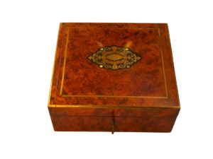 Square walnut box with brass and mother-of-pearl inlays.