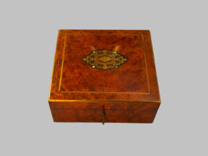 Square walnut box with brass and mother-of-pearl inlays.