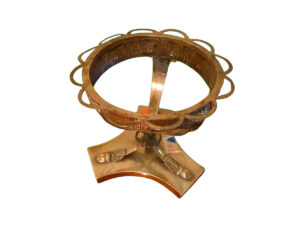 Silver bowl stand with three human heads and three legs.