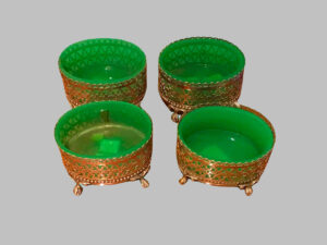 Four silver and green crystal salt cellars, openwork edges, four claw-shaped feet.