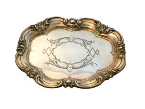 Bandeja de plata con bordes ondulados y cincelados, punteados en el centro.